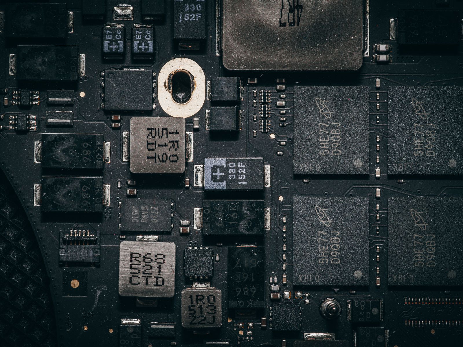 Macro view of a circuit board, dense with memory and power components.
